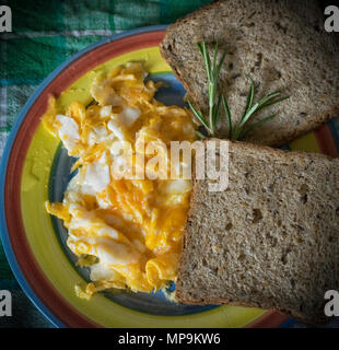 Scrambled eggs and two pieces of toast Stock Photo