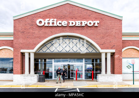 Sterling, USA - April 4, 2018: Office Depot store in Fairfax county, Virginia shop exterior entrance with sign, logo, doors , couple walking out Stock Photo