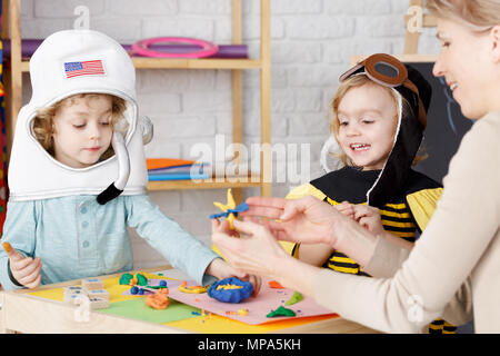 Little boy and girl dressed up on costume party in kindergarten Stock Photo