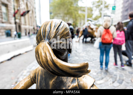 New York City, USA - October 30, 2017: Wall Street stock exchange The Fearless Girl statue facing Charging Bull metal in NYC Manhattan lower financial Stock Photo