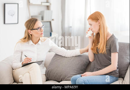 Medical concept - female psychologist comforting teenage girl with anxiety disorder Stock Photo