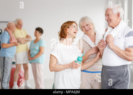 Group of senior friends in fitness club during rest time Stock Photo