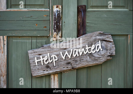 Help wanted sign on old green doors. Stock Photo