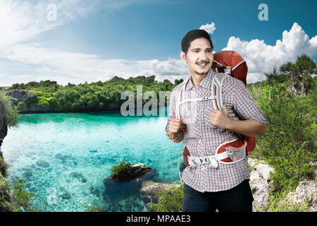Cheerful asian backpacker enjoying nature at travel destination Stock Photo