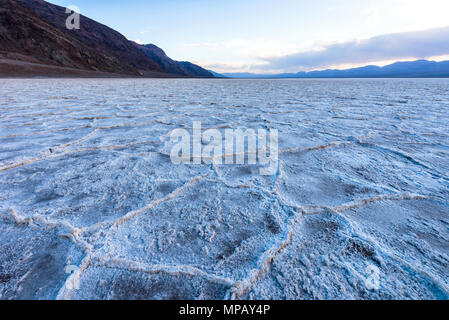 Salt Crusts - A close-up wide-angle view of salt crusts covering over vast salt flats of Badwater Basin at Death Valley National Park, California, USA Stock Photo