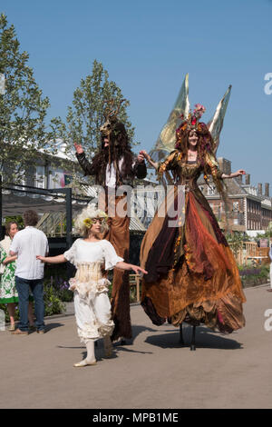 RHS Chelsea Flower show 2018 , Costumed Flower fairies on stilts Stock Photo