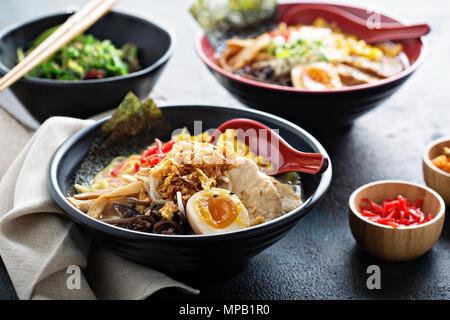 Spicy ramen bowls with noodles, pork and chicken Stock Photo
