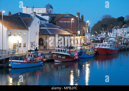 Fishing boats moored alongside Custom House Quay, viewed from the Town Bridge, in the evening. Weymouth Harbour. Dorset, England, UK. Stock Photo