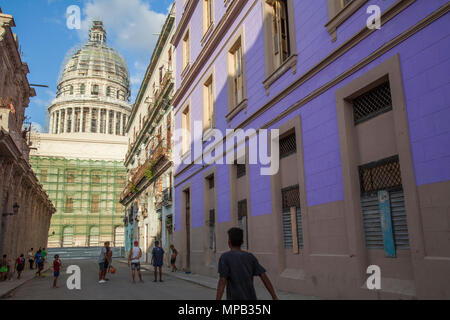 Local cuban children playing soccer and basketball in the streets of Old Havana Cuba with Capital building in background Stock Photo