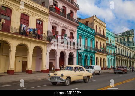 Classic 1950s cars driving down main street in Old Havana Cuba near the Capital building Stock Photo