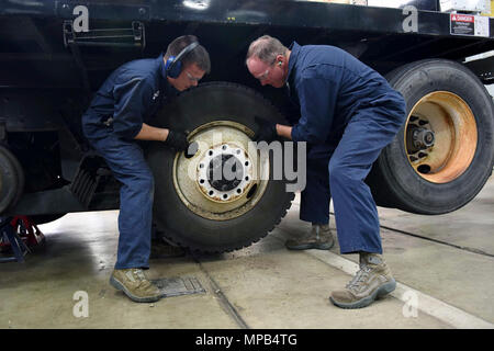 Col. Gregory Wood, 30th Space Wing vice commander, assists Senior Airman Christopher Champagne, 30th Logistics Readiness Squadron vehicle maintainer, remove the wheels of an Altec crane, April 7, 2017, at Vandenberg Air Force Base, Calif. Wood visited the 30th LRS to interact with Airmen and experience the mission. Stock Photo