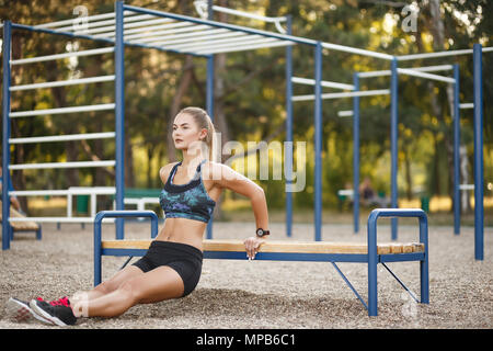 Woman doing dips workout Stock Photo