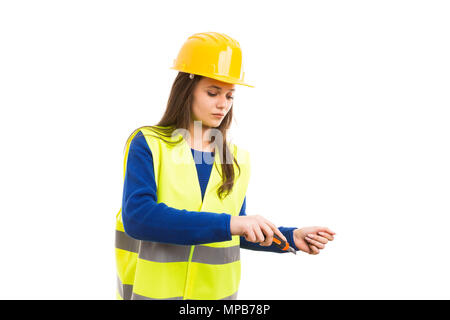 Young female worker or engineer using cutter blade as building hand cutting tool concept isolated on white background Stock Photo