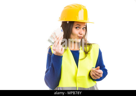 Young woman engineer or architect holding banknotes euro salary and having happy expression as payment concept isolated on white background. Stock Photo