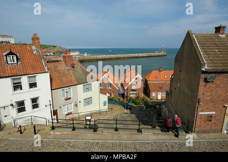 a view of Whitby Harbour in Yorkshire from the narrow cobbled streets close to Whitby Abbey Stock Photo