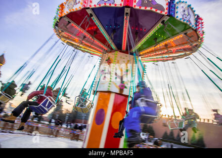 Abstract motion blur carousel spinning with kids, long exposure. Stock Photo