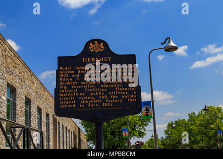 Hershey, PA, USA - May 21, 2018: An historical marker sign stands in front of the Hershey Chocolate Factory. Stock Photo
