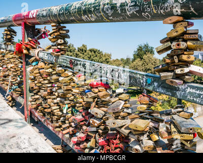 Pedestrian bridge over River Mapocho with close up of mass of love locks and graffiti, Racamalac bridge, Santiago, Chile Stock Photo