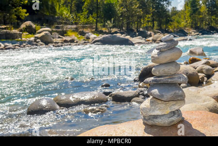 Balance and wellness retro spa concept, inspiration, zen-like and well being tranquil composition. Close-up of white pebbles stack balanced stones on t Stock Photo