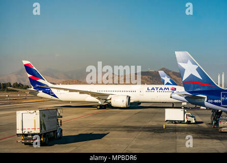 View from plane window, Santiago International airport of LATAM aeroplanes on apron, with new and old airline logos, joining LAN and TAM airlines Stock Photo