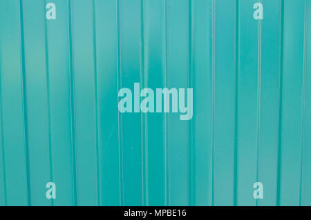 Background of green metal siding, corrugated iron sheet for exterior decoration during construction Stock Photo