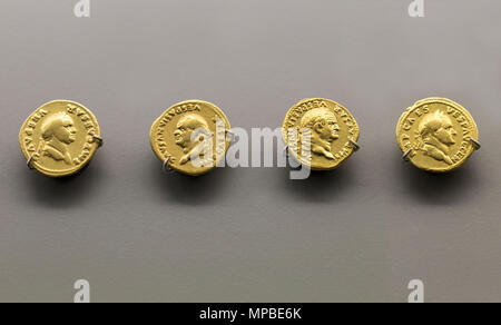 Merida, Spain - December 20th, 2017: Gold Roman Imperial coins bearing the bust of Emperor Vespasian. National Museum of Roman Art in Merida, Spain Stock Photo