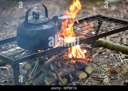 Blackened kettle on an open campfire Stock Photo