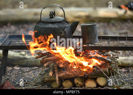 Blackened kettle on an open campfire Stock Photo