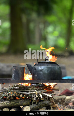 Blackened kettle on an open campfire Stock Photo
