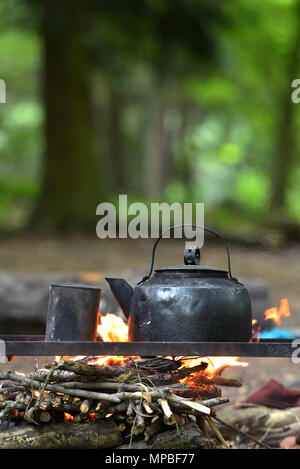 Blackened kettle on an open campfire Stock Photo