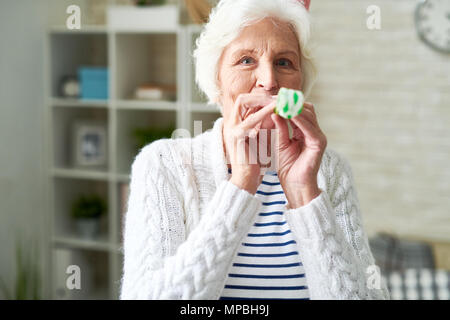 Happy Senior Lady Celebrating Holiday Stock Photo