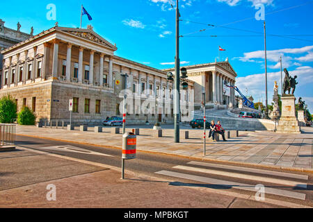 Vienna, Austria - August 31, 2013: Austrian Parliament Building in Ringstrasse with people passing by, Vienna in Austria. Stock Photo