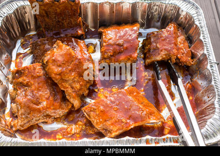 Marinated pork back ribs ready to be grilled on barbecue. Stock Photo