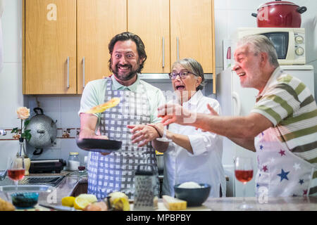 crazy family scene with flying omelette and mad chef son of an aged couple. Nice expressions for funny situation. Stock Photo