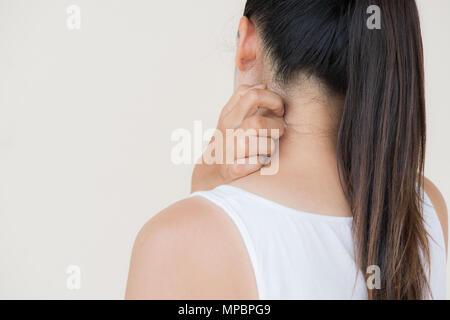 Close up woman hand scratch the itch by hand at neck and back. Healthcare and medical concept. Stock Photo