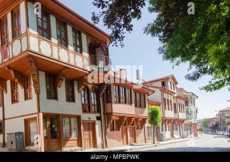 Beautiful old street in downtown with houses with wooden shutters in the classic Turkish Ottoman style, Turkey, center of Afyon The two-storyed buildi Stock Photo