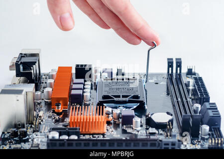 Installing the processor in the computer's motherboard. Computer Assembling Stock Photo