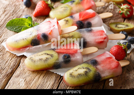 Natural berry-fruit ice with fresh strawberries, blueberries and kiwi fruit close-up on the table. horizontal Stock Photo