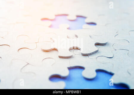 missing puzzle pieces on a blue background. Conceptual photo Stock Photo