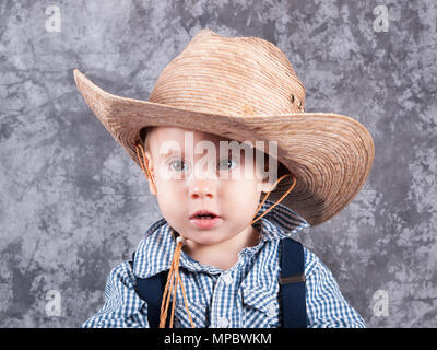 Little cute kid in cowboy straw hat Stock Photo