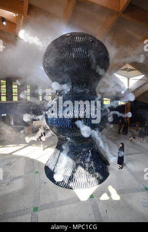 Eden Project, Cornwall, UK. 22nd May 2018. Measuring nearly nine metres tall,  Blue fires vapour rings from 32 cannons and is possibly the world’s biggest ceramic sculpture The installation is the centrepiece of Invisible Worlds, a major new permanent exhibition at the home of the famous Biomes, revealing the world beyond our senses: too big, too small, too fast, too slow, too far away in space and time. At almost nine metres (30ft) tall and weighing 20 tonnes,  Blue (Infinity Blue) is an immersive sculpture that pays homage to cyanobacteria. Credit: Simon Maycock/Alamy Live News Stock Photo