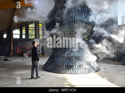 Eden Project, Cornwall, UK. 22nd May 2018. Measuring nearly nine metres  tall, Blue fires vapour rings from 32 cannons and is possibly the world's  biggest ceramic sculpture.Seen here one of the artists Alexander Groves.  The installation is the centrepiece of