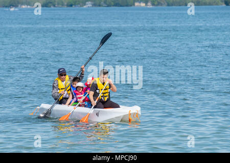 A family unit spanning 3 generations enjoy the lake on a beautiful Victoria Day long weekend. Stock Photo