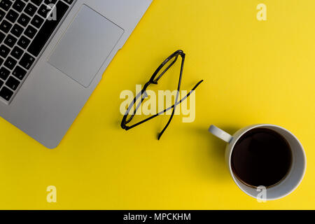 Laptop computer notebook on bright yellow background Stock Photo