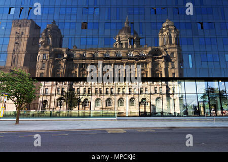 Port of Liverpool building reflected in the windows of the Latitude building on Mann Island on Liverpool waterfront. Stock Photo