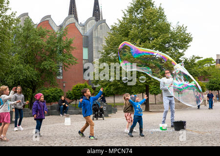 Europe, Germany, Cologne, man makes huge soap bubbles at the Rhine garden in the old part of the town.  Europa, Deutschland, Koeln, Mann macht grosse  Stock Photo