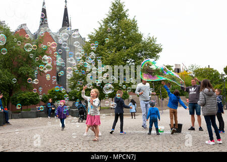 Europe, Germany, Cologne, man makes soap bubbles at the Rhine garden in the old part of the town.  Europa, Deutschland, Koeln, Mann macht Seifenblasen Stock Photo