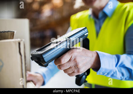 Warehouse woman worker with barcode scanner. Stock Photo