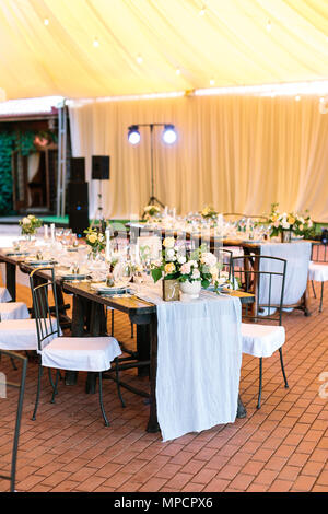 performance, wedding, party concept. beautiful space for celebrating one of the most important event, marriage. there are served tables under large te Stock Photo