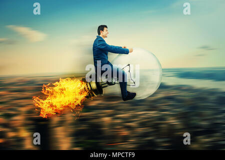 Happy businessman drive on a flying light bulb rocket, lamp with fire flame on back fly fast over the city. Business success and high targets. Stock Photo